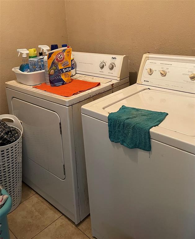 7554 Rice Lane Dallas, TX 75241 - Photo 14 of 16 a utility room with dryer and washer