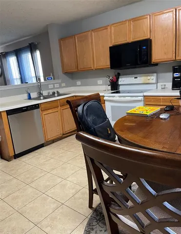 a kitchen with a sink and a stove top oven