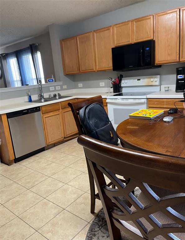 7554 Rice Lane Dallas, TX 75241 - Photo 7 of 16 a kitchen with a sink and a stove top oven
