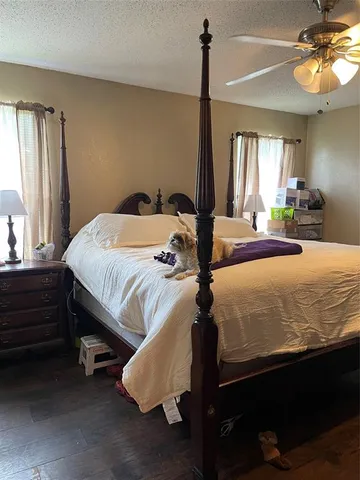 a bed sitting in a bedroom next to a window