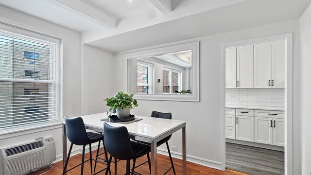 a view of a dining room with furniture and window