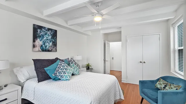 a bedroom with a bed and a painting on the wall