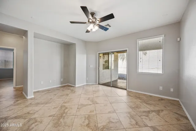 a view of an empty room with a ceiling fan