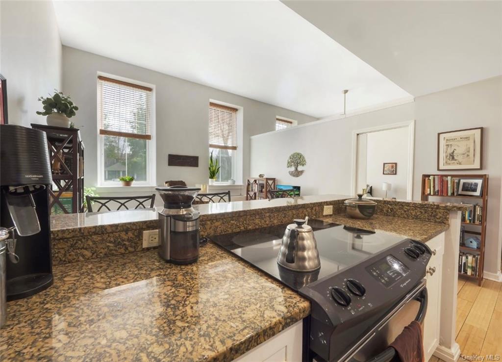 a kitchen with a stove a sink and a granite counter tops