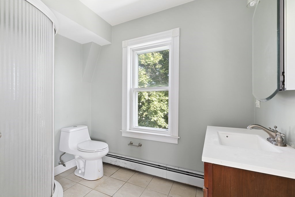 53 Prospect Avenue Winthrop, MA 02152 - Photo 17 of 18 a white toilet sitting next to a bathroom sink