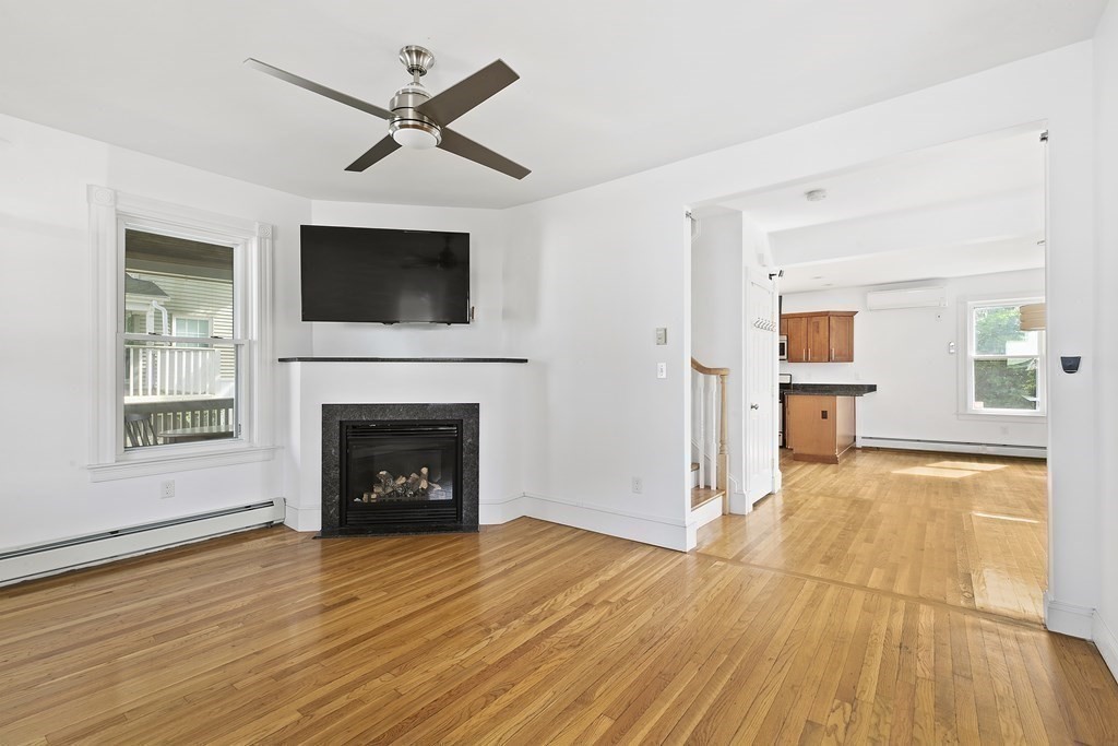 53 Prospect Avenue Winthrop, MA 02152 - Photo 4 of 18 a view of a livingroom with wooden floor and a fireplace