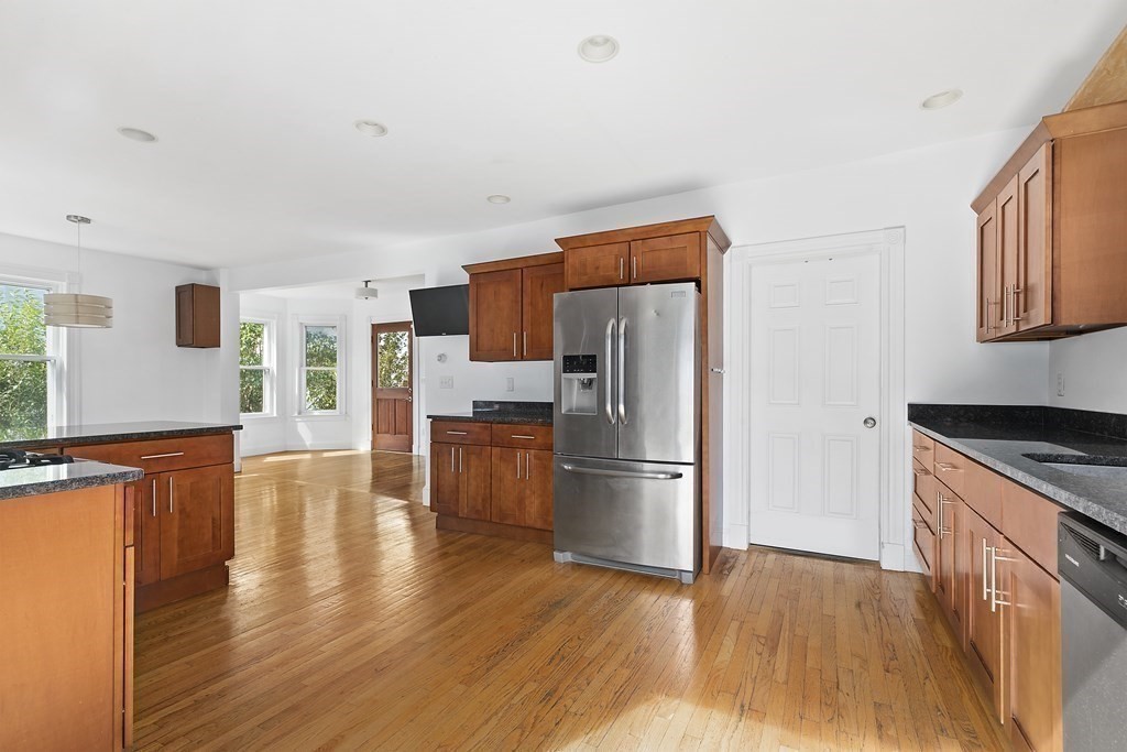 53 Prospect Avenue Winthrop, MA 02152 - Photo 8 of 18 a kitchen with stainless steel appliances a refrigerator and wooden floor