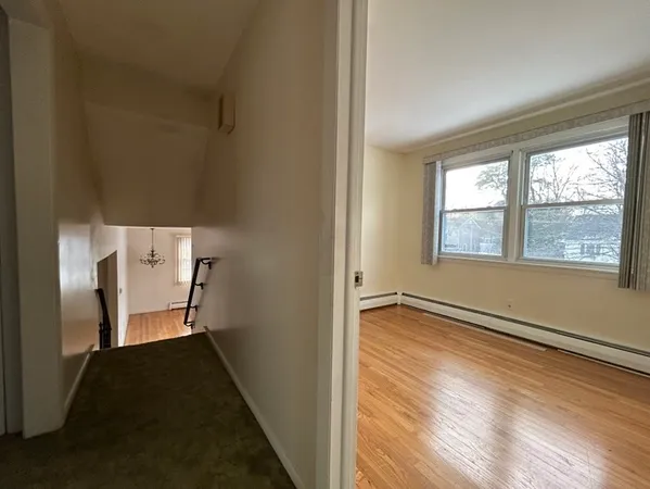a living room with a couch and a stove with wooden floor