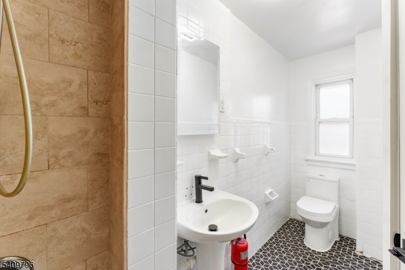 521 Bayway, Unit 1R Elizabeth, NJ 07202 - Photo 8 of 8 a bathroom with a sink toilet and shower