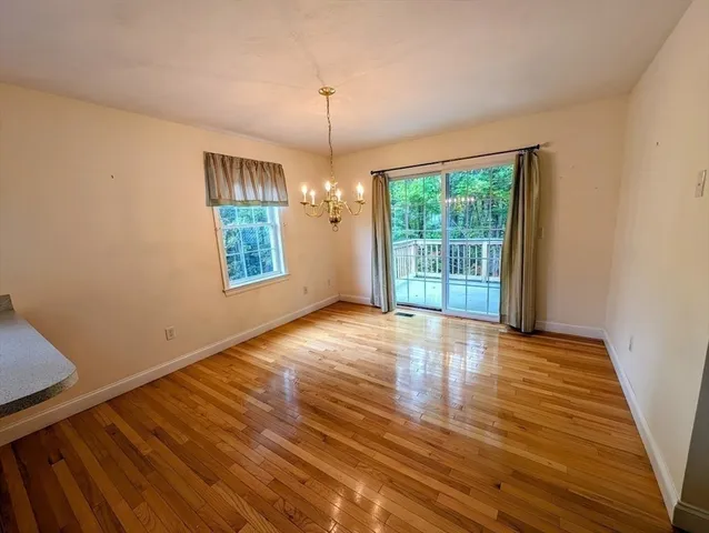 a view of a room with wooden floor and windows