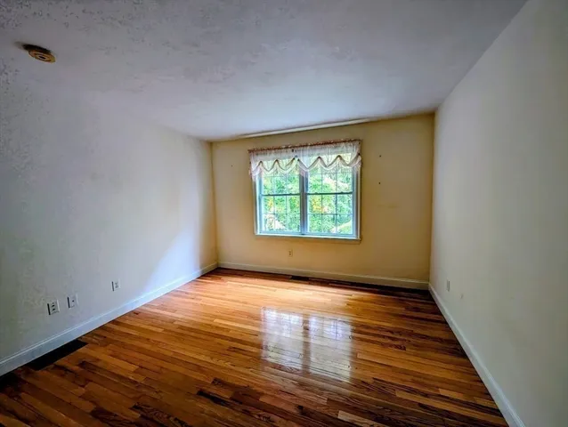 a view of a room with wooden floor
