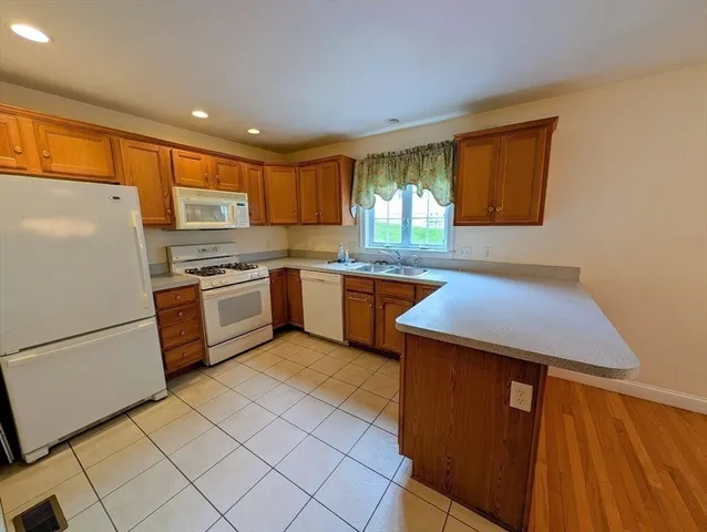 a kitchen with stainless steel appliances granite countertop a refrigerator sink and cabinets