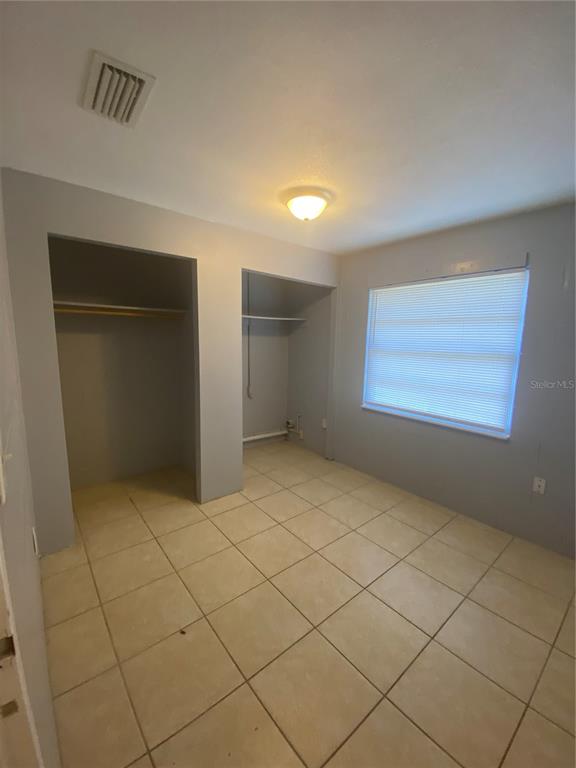 1119 McNamee Street, Unit B Leesburg, FL 34748 - Photo 6 of 13 an empty room with windows