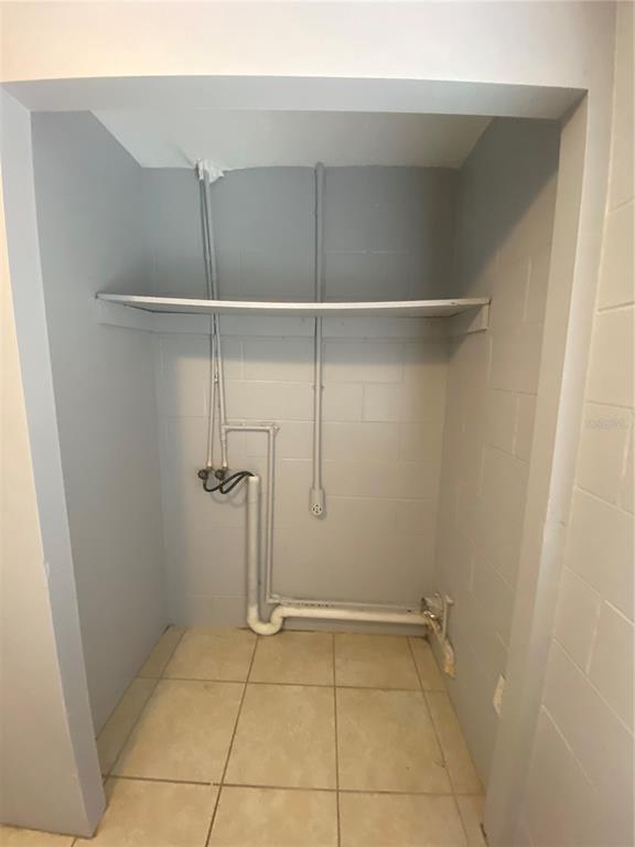 1119 McNamee Street, Unit B Leesburg, FL 34748 - Photo 7 of 13 a view of a room with racks on the wall