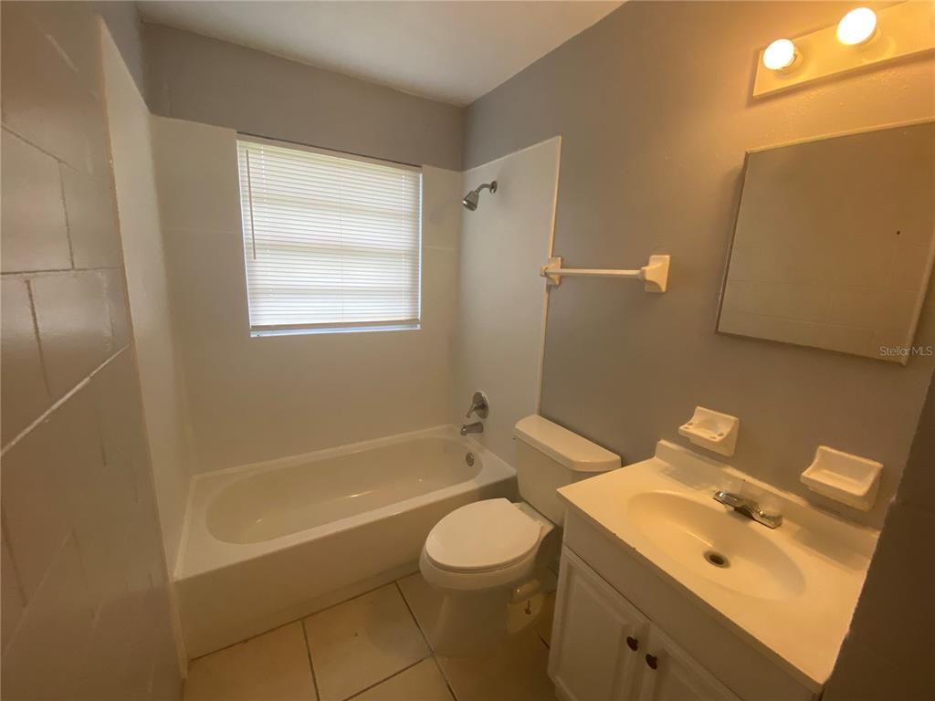 1119 McNamee Street, Unit B Leesburg, FL 34748 - Photo 9 of 13 a bathroom with a sink a toilet and shower
