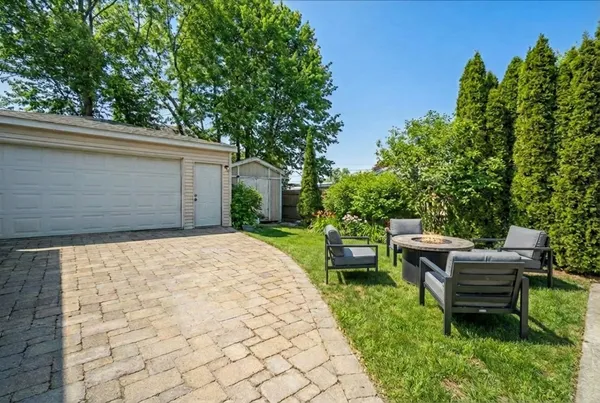 a view of backyard with outdoor seating and green space