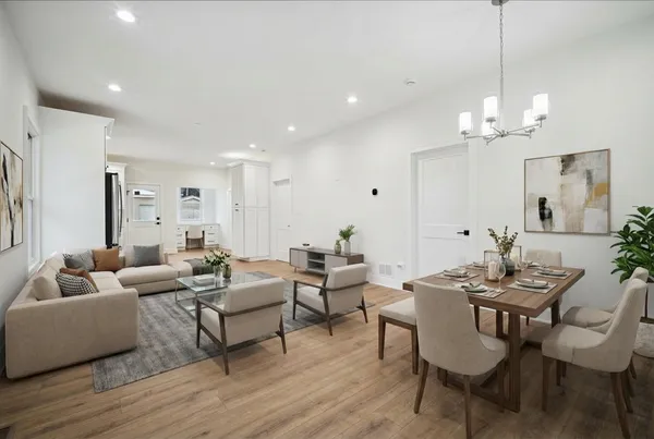 a living room with furniture a window and a chandelier
