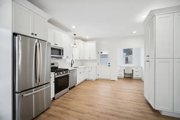a kitchen with stainless steel appliances a refrigerator sink and cabinets