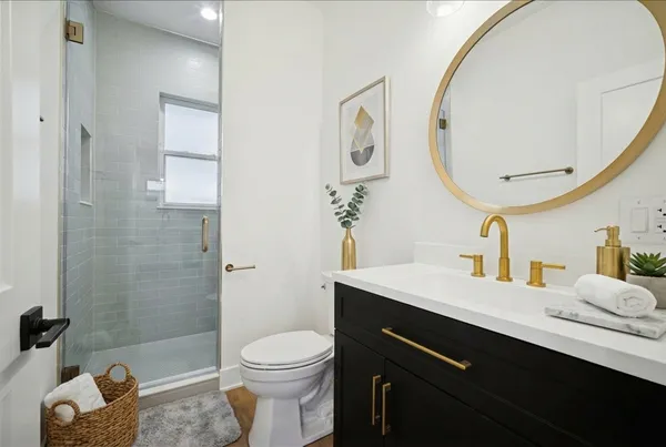 a bathroom with a sink a toilet and a mirror