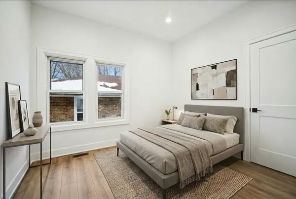 a bedroom with a bed and a window