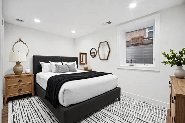 a bedroom with bed and a window