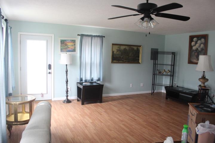 2075 Lock B Road North Clarksville, TN 37043 - Photo 17 of 26 a view of a livingroom with a flat screen tv wooden floor and a window