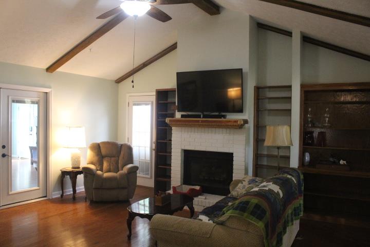 2075 Lock B Road North Clarksville, TN 37043 - Photo 10 of 26 a living room with furniture a flat screen tv and a fireplace