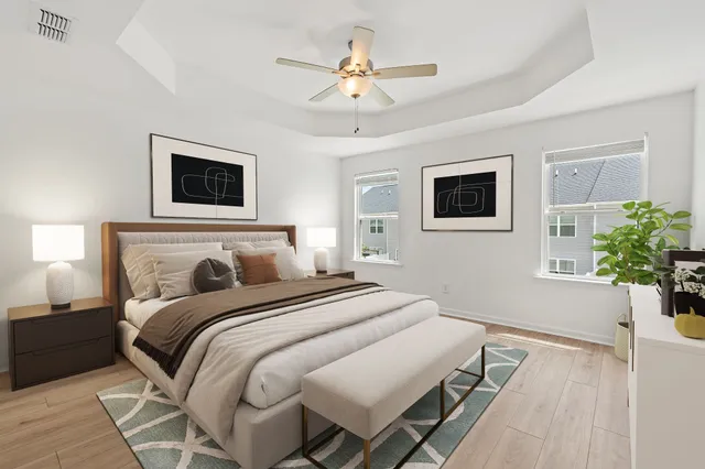 a bedroom with a large bed and a chandelier
