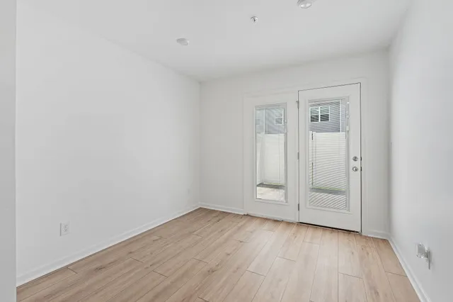 a view of an empty room with wooden floor