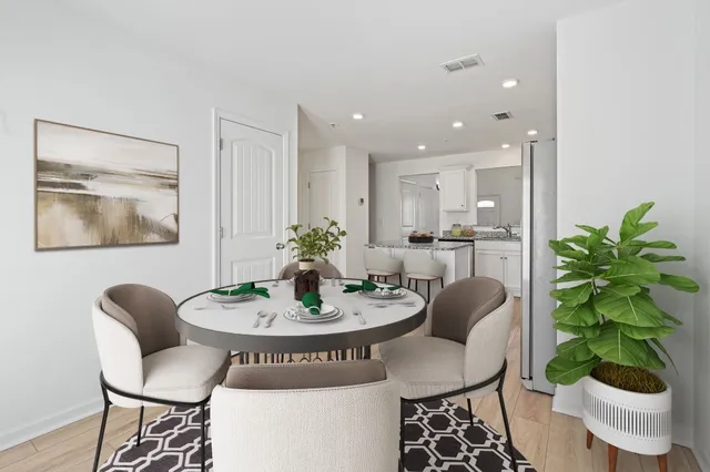 a dining room with furniture and wooden floor
