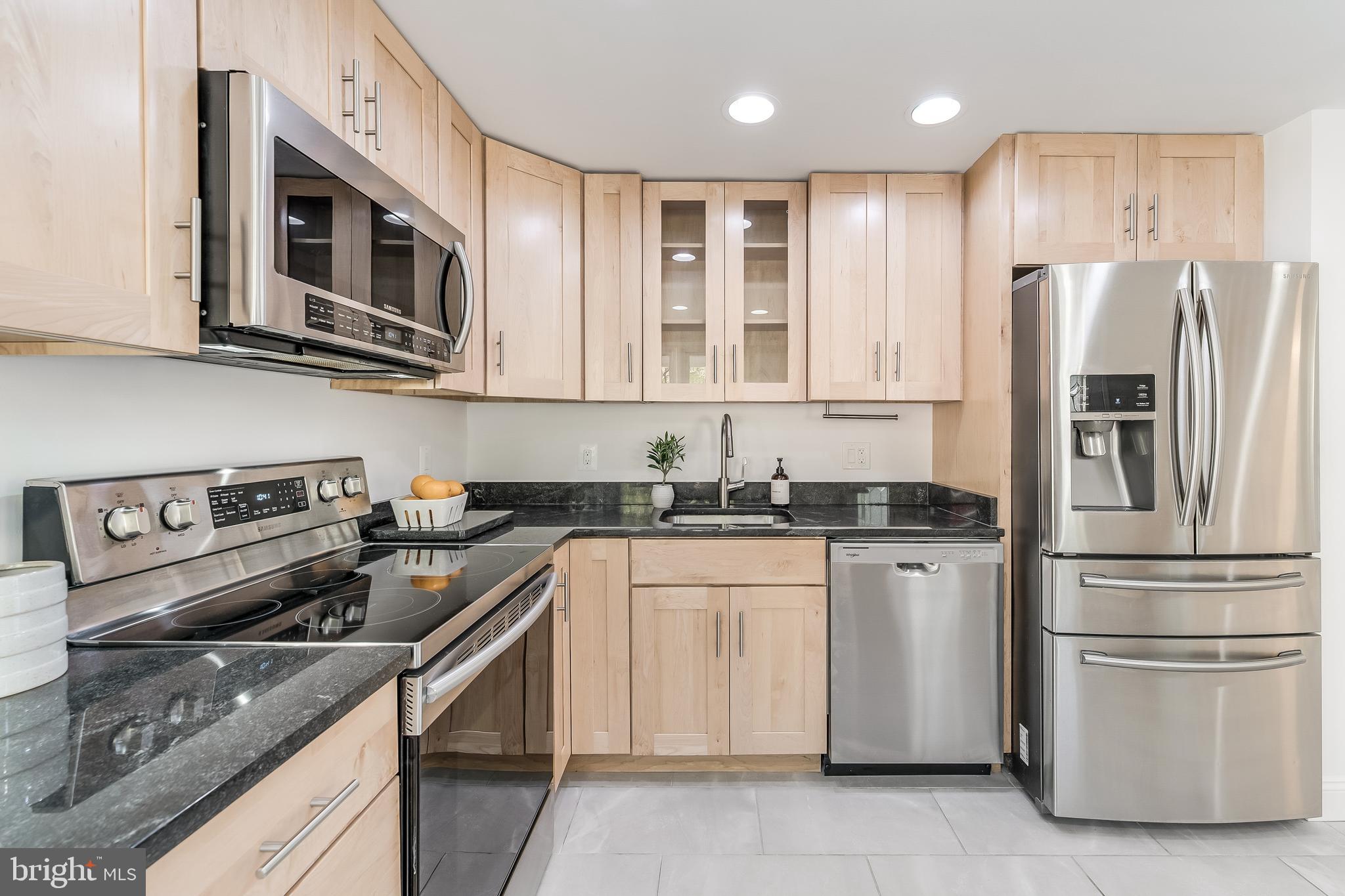 11257 Silentwood Lane Reston, VA 20191 - Photo 11 of 44 a kitchen with stainless steel appliances granite countertop a refrigerator stove a sink dishwasher and microwave oven