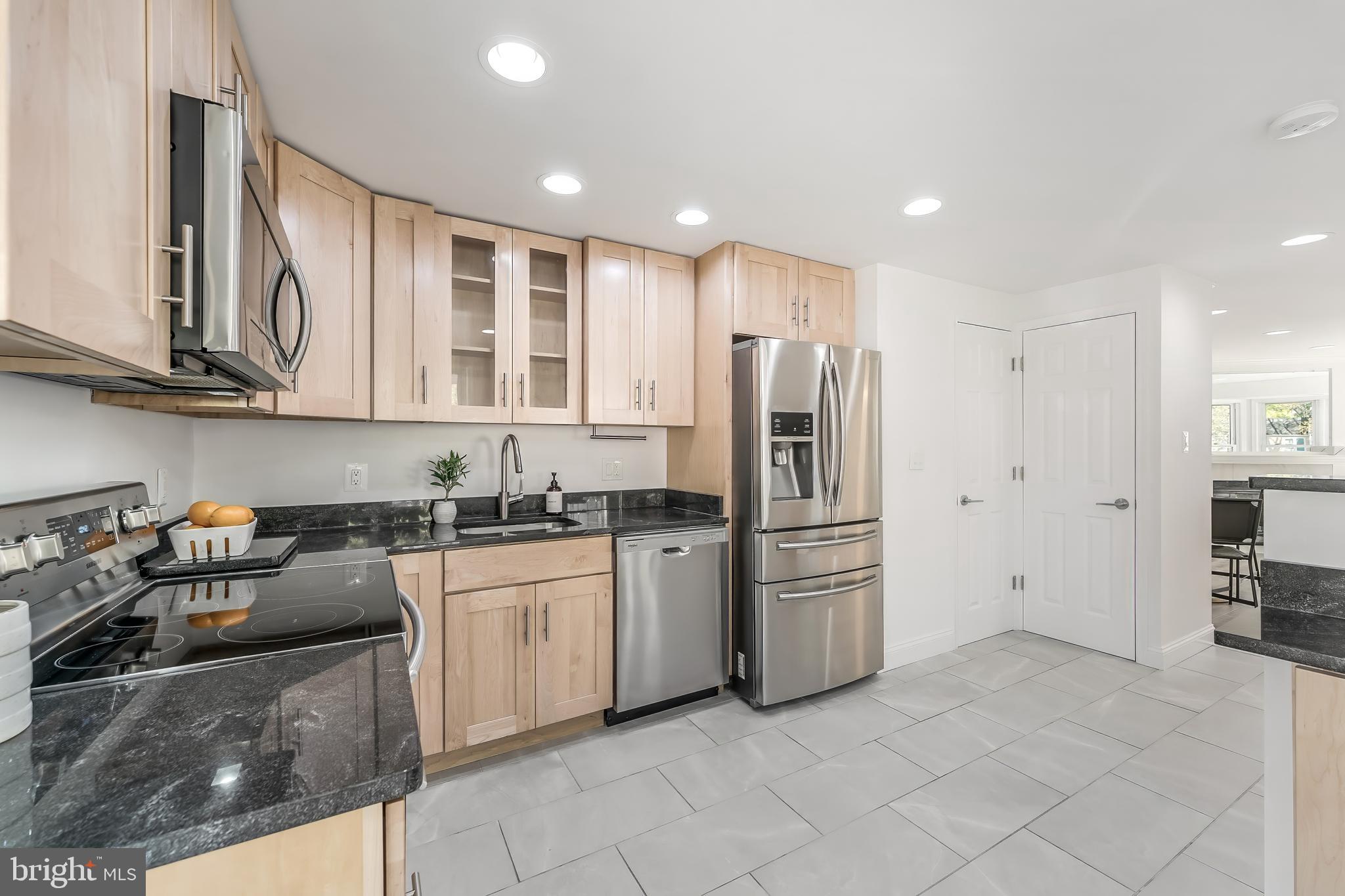 11257 Silentwood Lane Reston, VA 20191 - Photo 13 of 44 a kitchen with stainless steel appliances granite countertop a refrigerator sink and stove