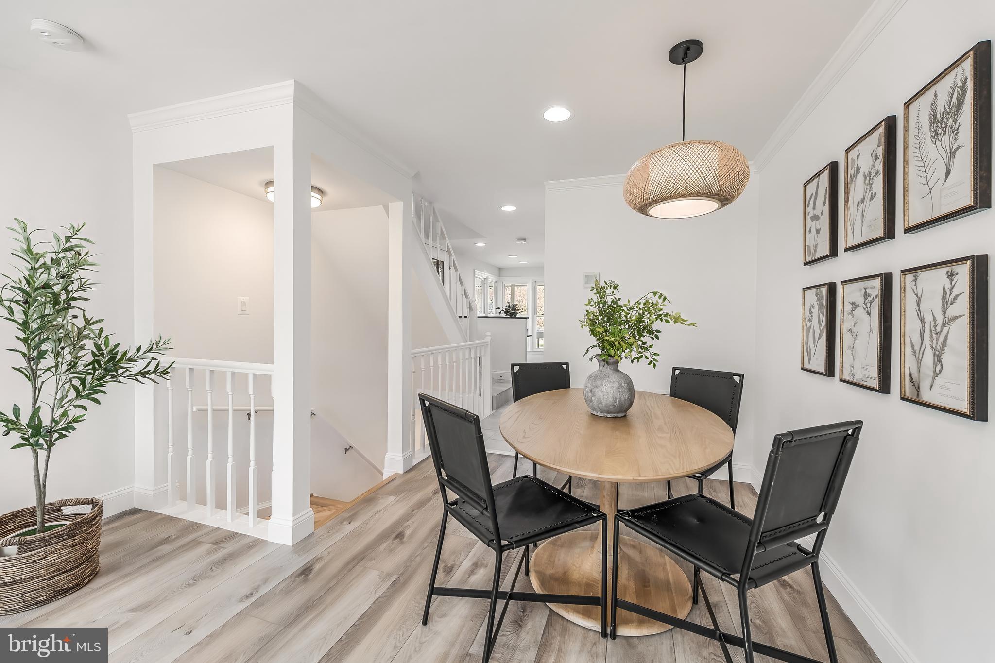 11257 Silentwood Lane Reston, VA 20191 - Photo 14 of 44 a dining room with furniture potted plants and wooden floor