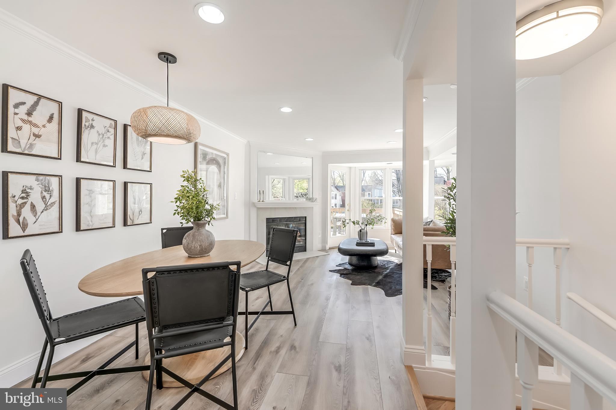 11257 Silentwood Lane Reston, VA 20191 - Photo 15 of 44 a dining room with furniture a chandelier and wooden floor