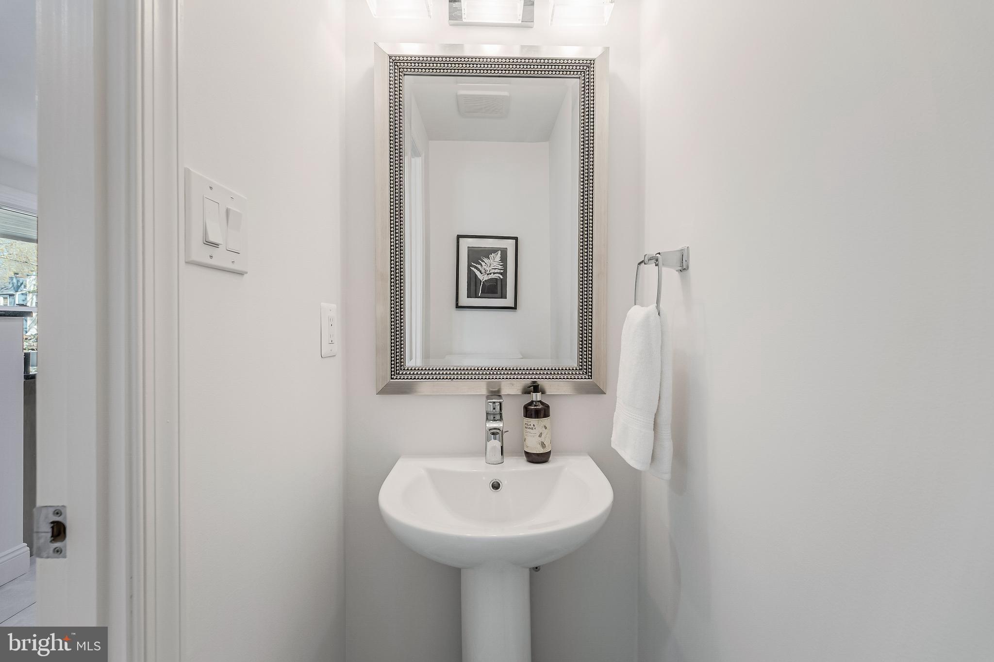 11257 Silentwood Lane Reston, VA 20191 - Photo 22 of 44 a bathroom with a sink and a mirror