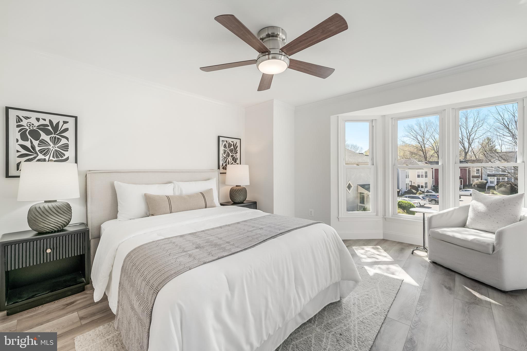 11257 Silentwood Lane Reston, VA 20191 - Photo 24 of 44 a spacious bedroom with a bed and ceiling fan