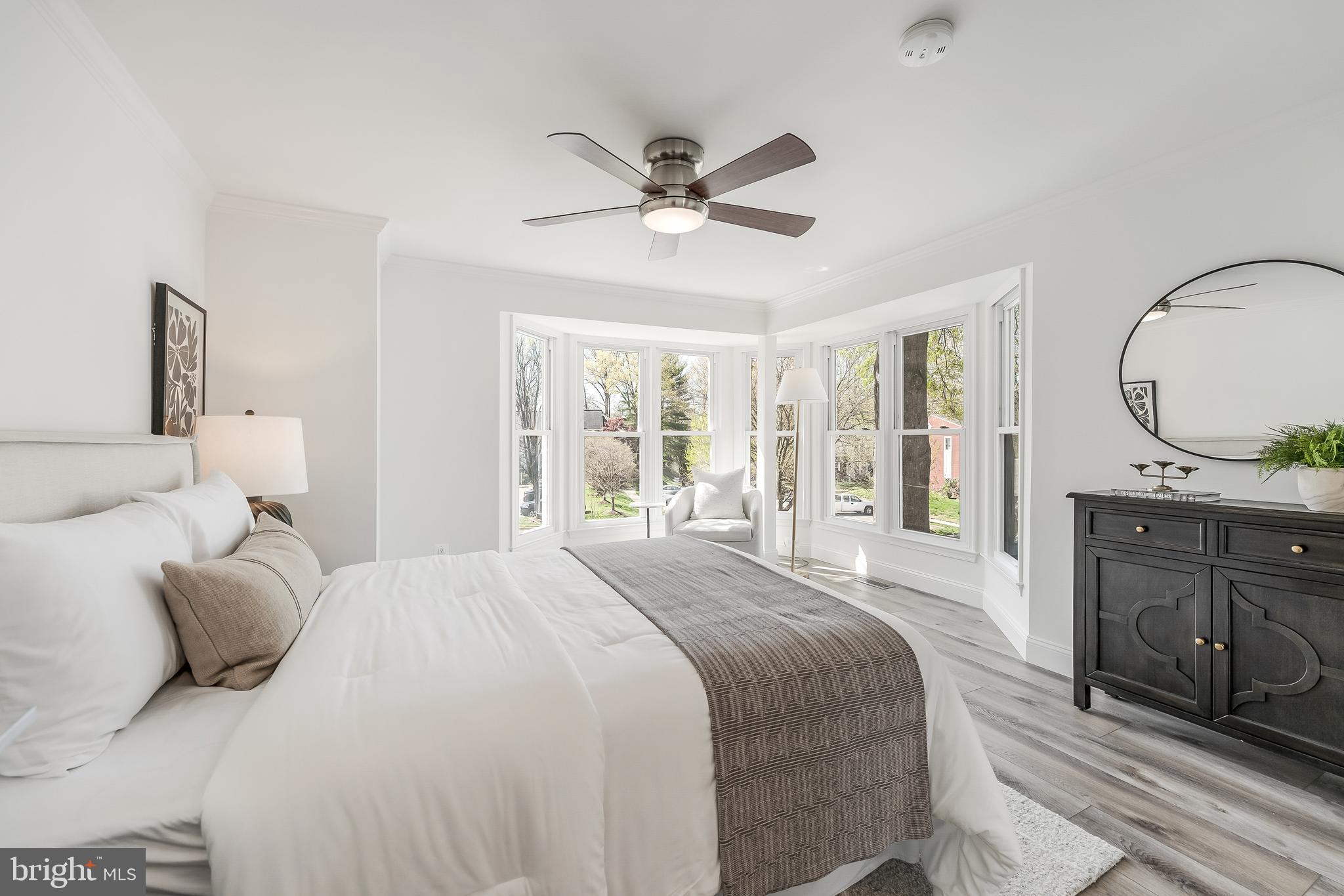 11257 Silentwood Lane Reston, VA 20191 - Photo 25 of 44 a bedroom with a bed and a dresser with wooden floor
