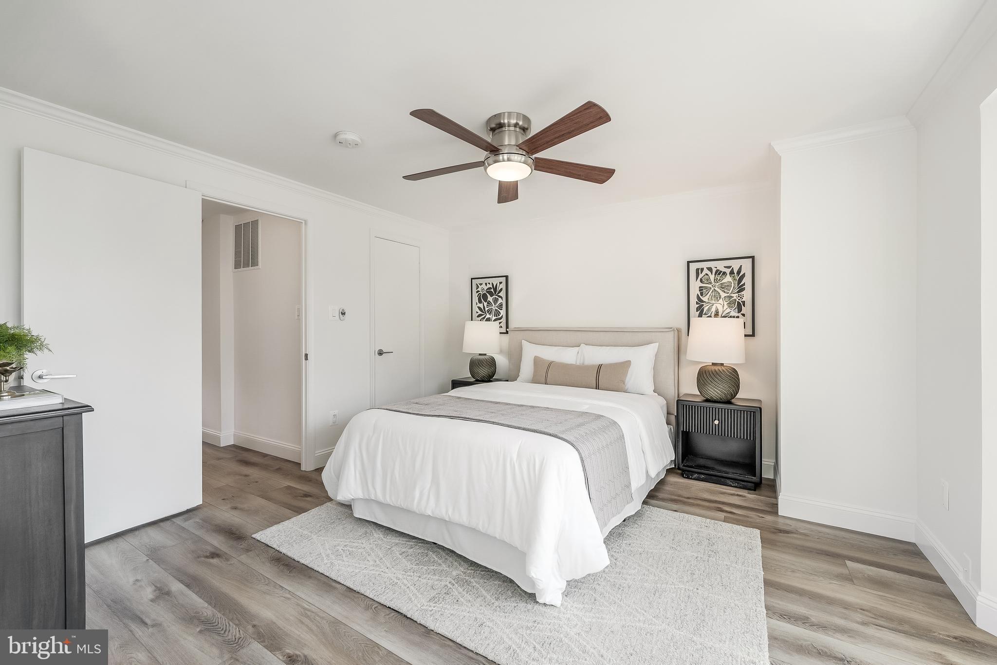 11257 Silentwood Lane Reston, VA 20191 - Photo 26 of 44 a bedroom with a bed and a ceiling fan