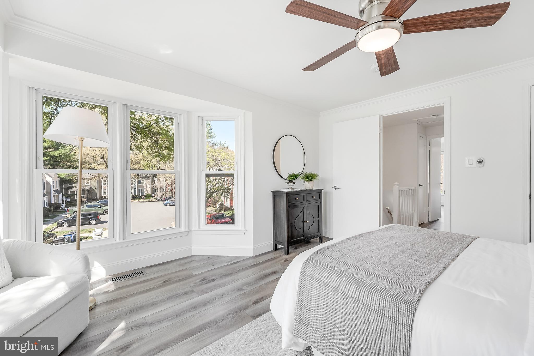 11257 Silentwood Lane Reston, VA 20191 - Photo 27 of 44 a bedroom with a bed and a chandelier