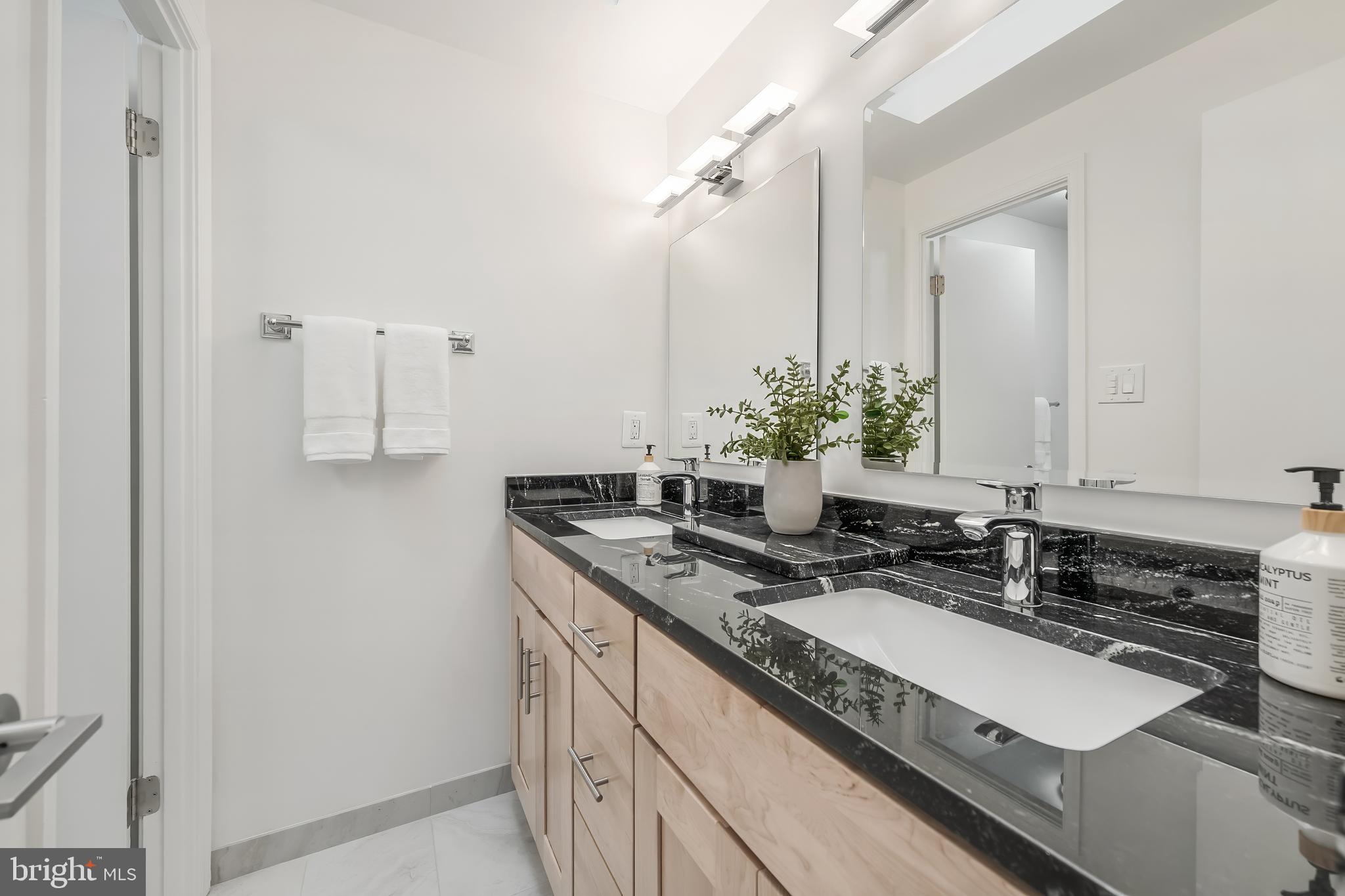 11257 Silentwood Lane Reston, VA 20191 - Photo 29 of 44 a bathroom with a sink and a mirror