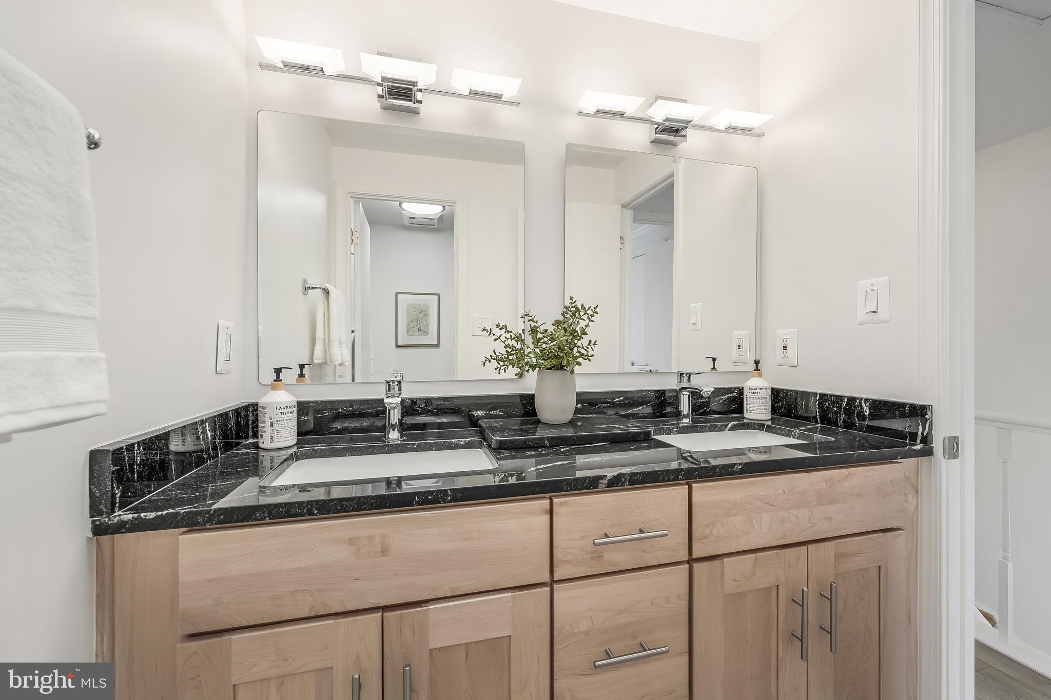 11257 Silentwood Lane Reston, VA 20191 - Photo 31 of 44 a bathroom with a granite countertop sink and a mirror
