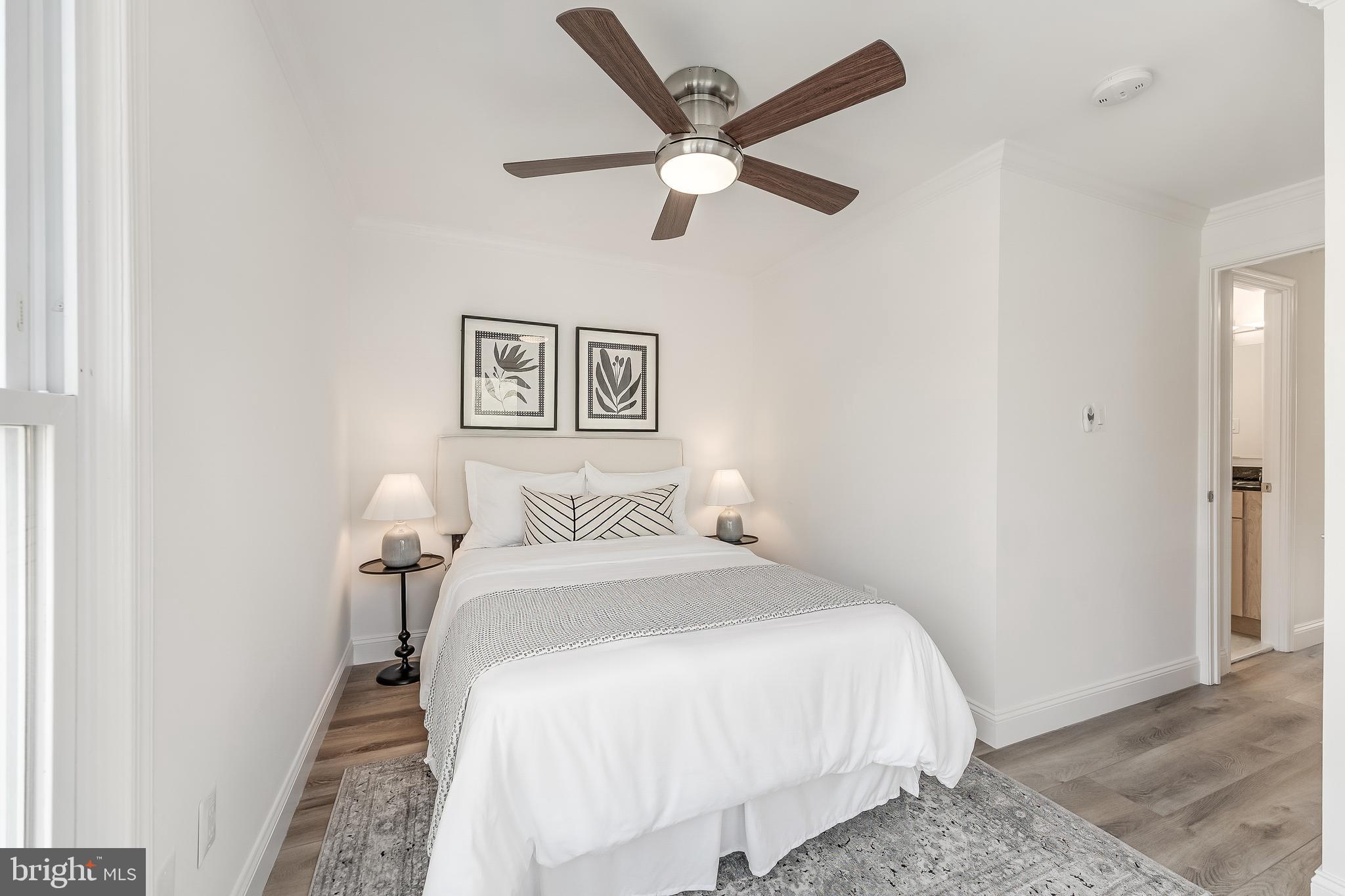 11257 Silentwood Lane Reston, VA 20191 - Photo 32 of 44 a bedroom with a bed and a ceiling fan