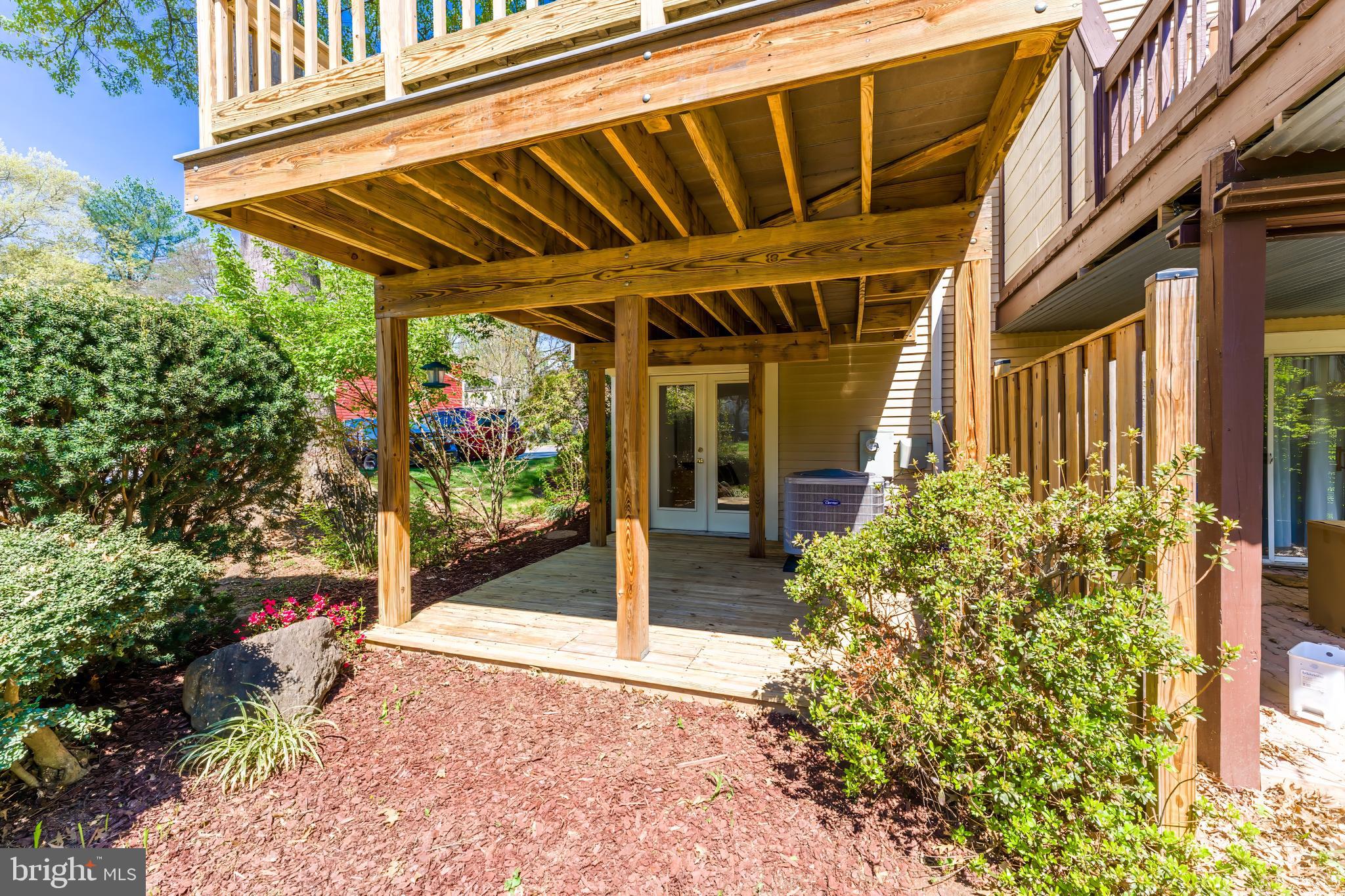 11257 Silentwood Lane Reston, VA 20191 - Photo 43 of 44 a view of a porch with a table and chairs and potted plants