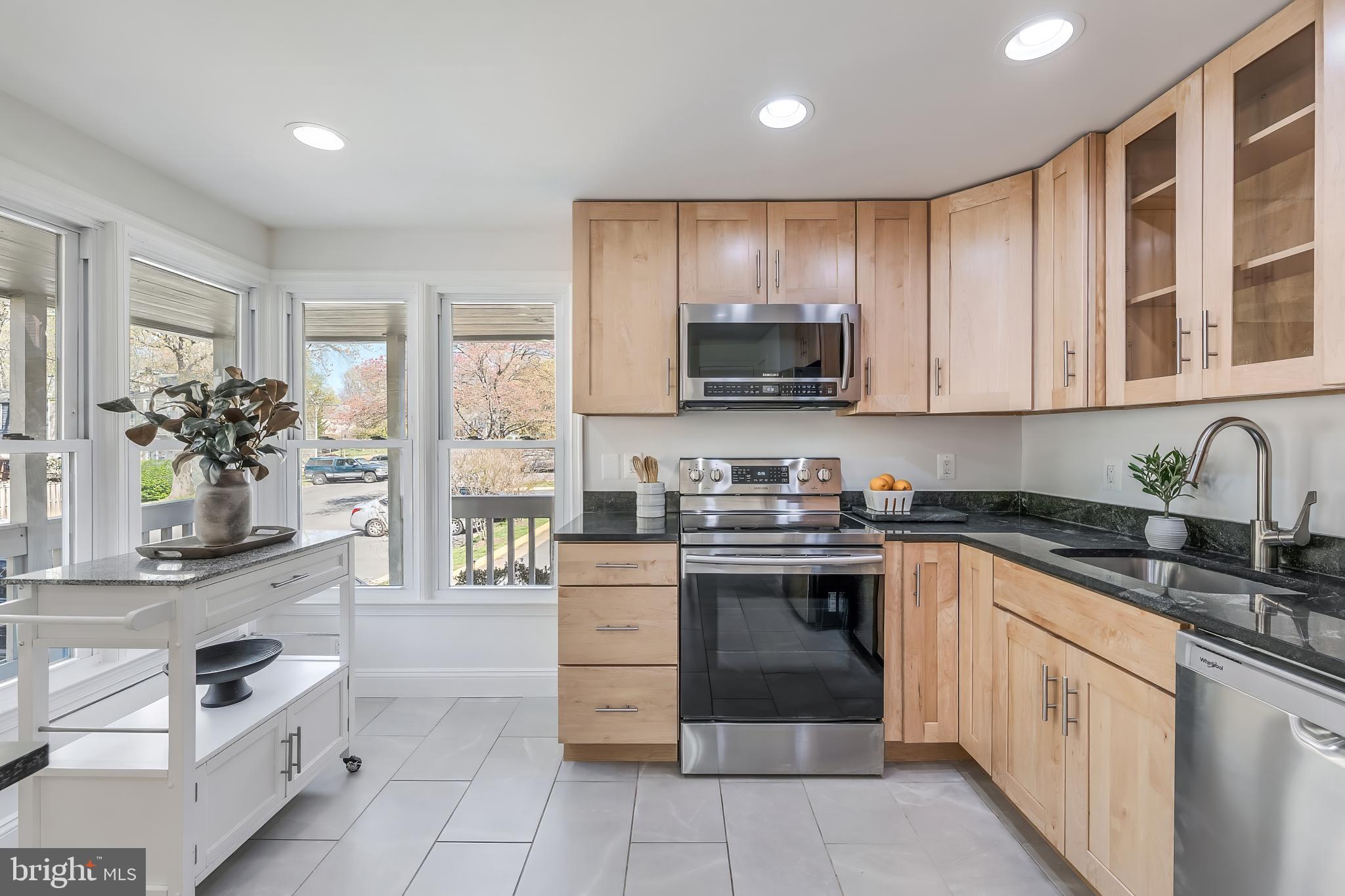 11257 Silentwood Lane Reston, VA 20191 - Photo 9 of 44 a kitchen with stainless steel appliances granite countertop a stove and cabinets