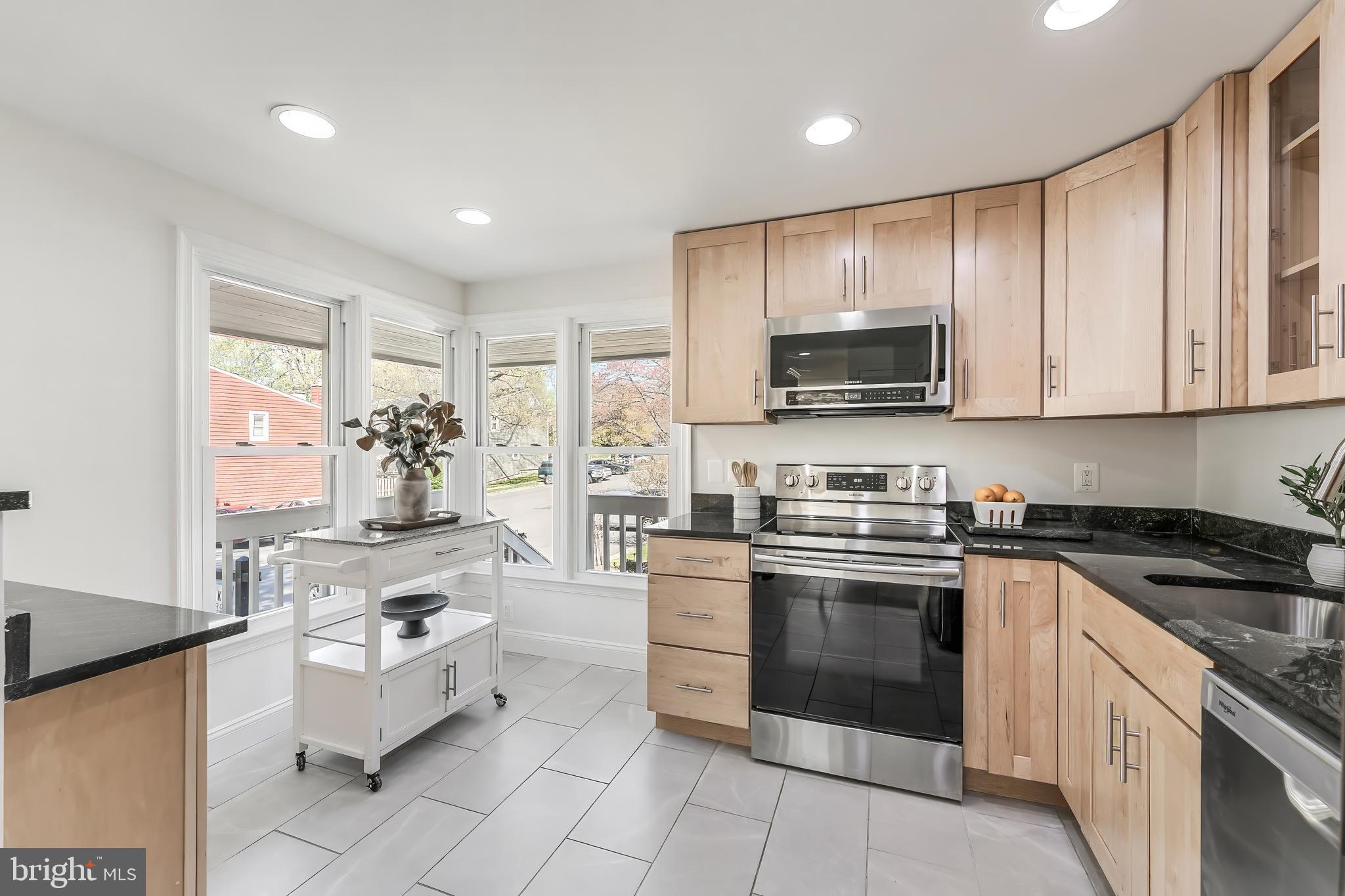 11257 Silentwood Lane Reston, VA 20191 - Photo 10 of 44 a kitchen with stainless steel appliances granite countertop a stove top oven a sink dishwasher and a refrigerator