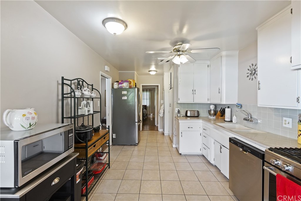 3451 Mono Drive Riverside, CA 92506 - Photo 8 of 24 a kitchen with stainless steel appliances a stove refrigerator and cabinets
