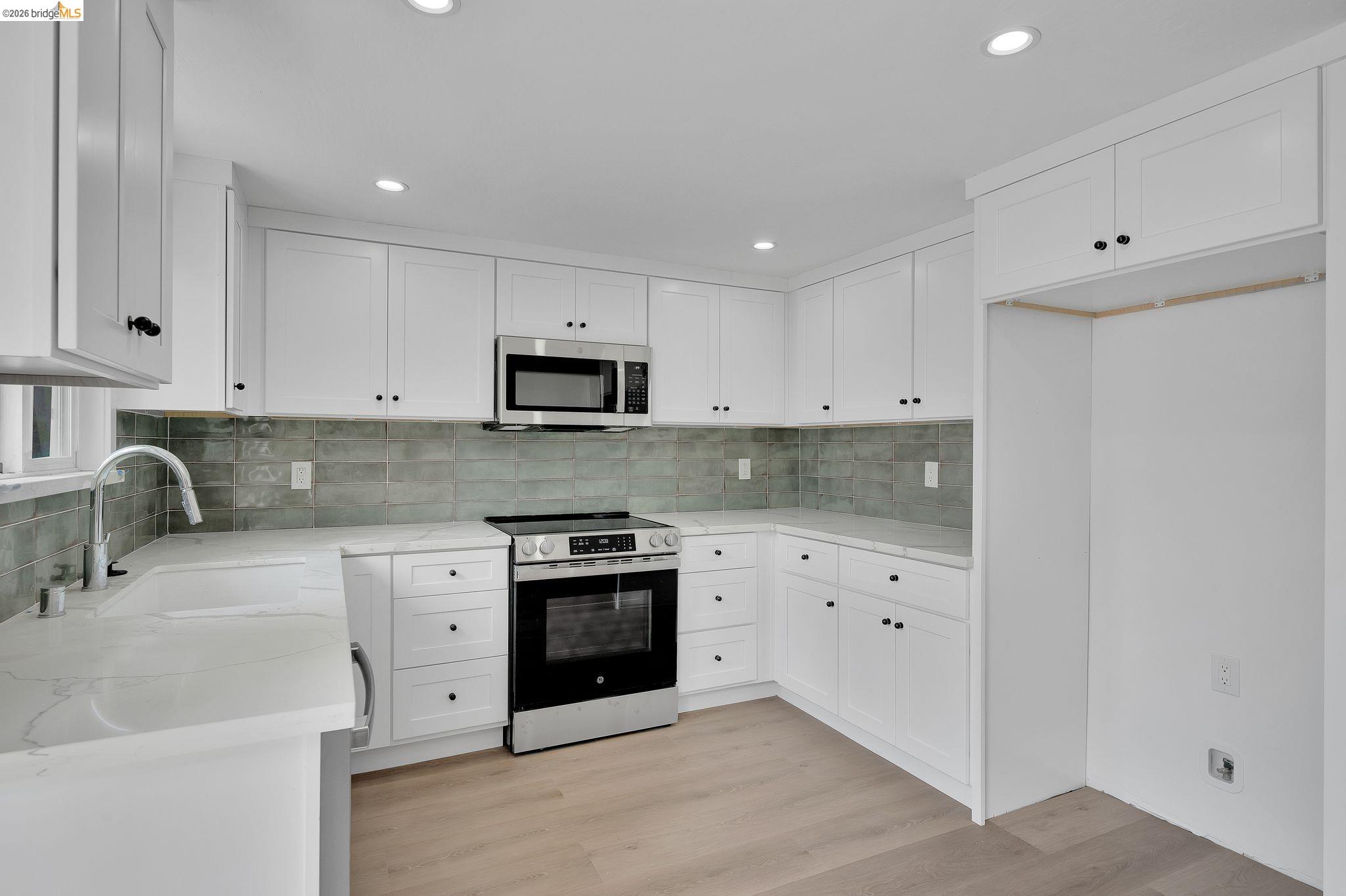 1808 Wildbrook Court, Unit D Concord, CA 94521 - Photo 13 of 47 a kitchen with stainless steel appliances granite countertop a stove a sink and a refrigerator