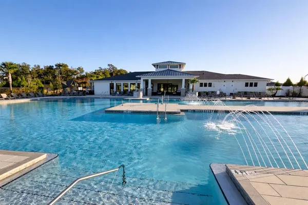 a view of a swimming pool with lounge chairs