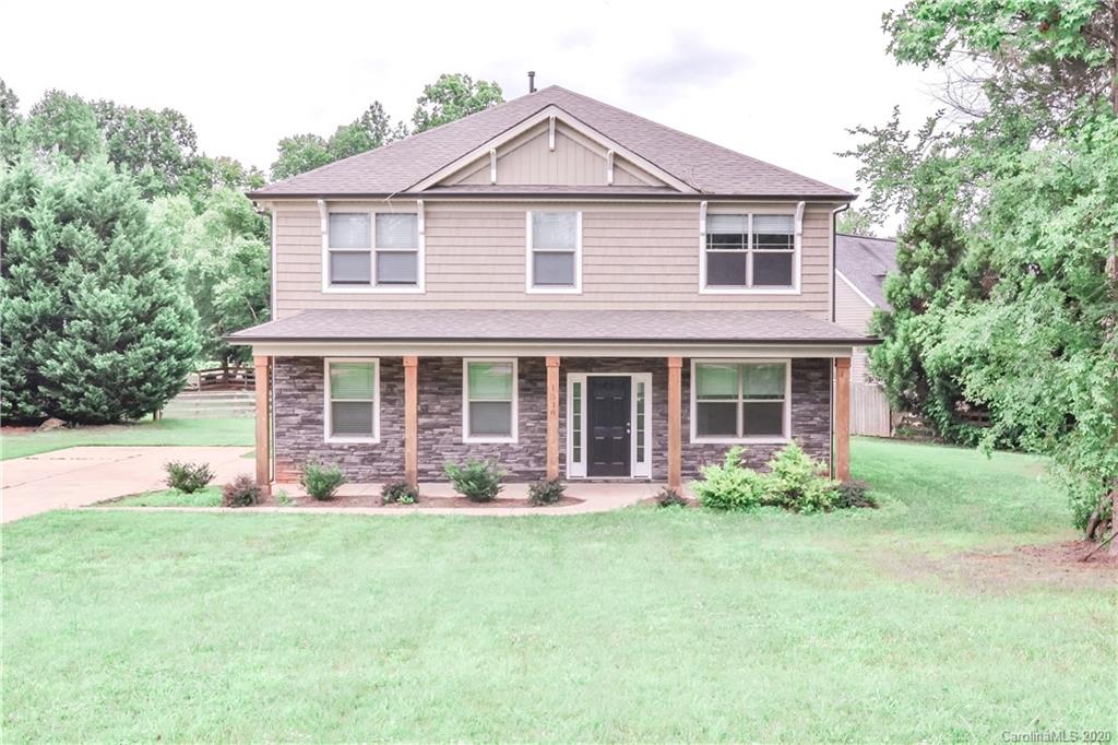 1338 Armstrong Road Belmont, NC 28012 - Photo 1 of 14 a front view of a house with garden and porch