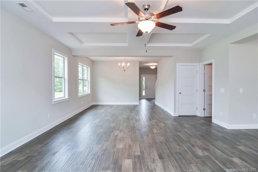 1338 Armstrong Road Belmont, NC 28012 - Photo 2 of 14 a view of an empty room with a window and wooden floor